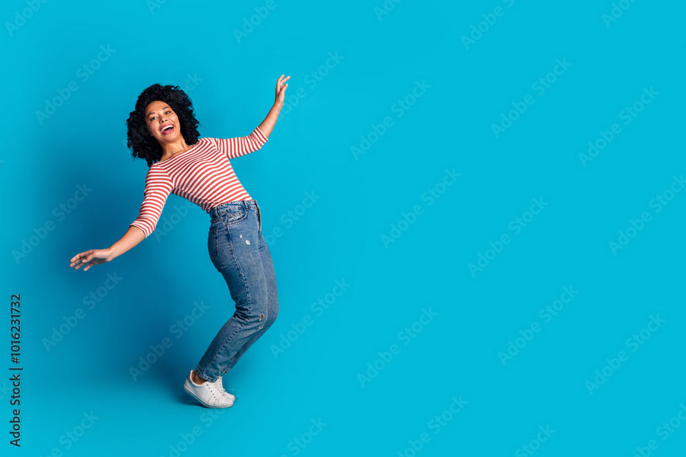 Obraz premium Photo of funky lovely optimistic girl wear stylish clothes falling down empty space isolated on blue color background