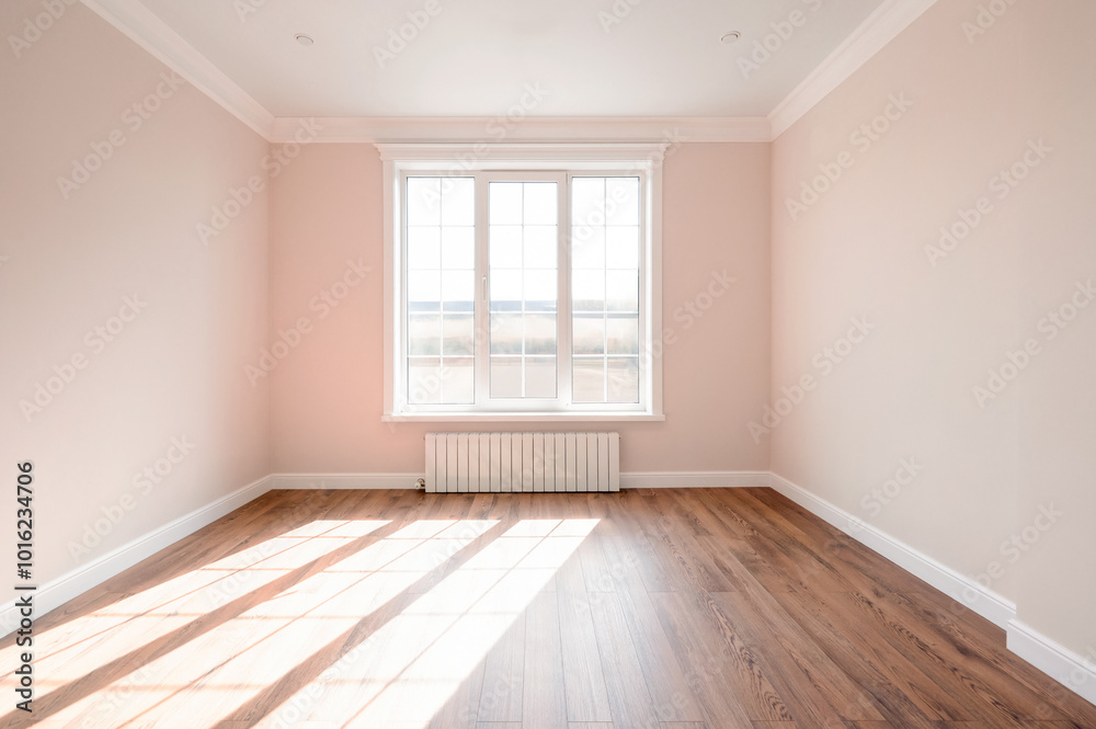 Obraz premium A spacious empty room featuring soft pink walls, wooden flooring, and sunlight streaming through the window