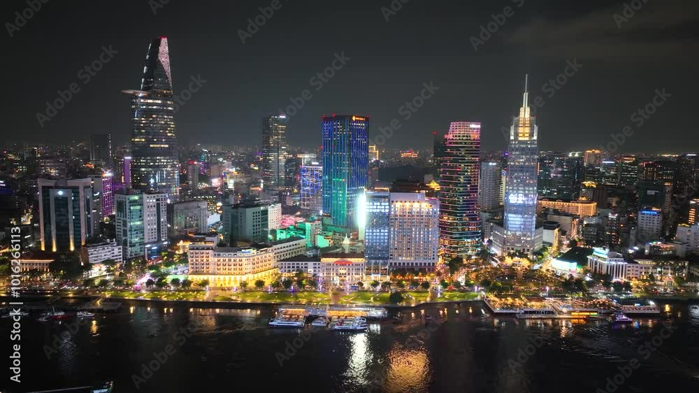 Neon reflections in waters deep, but Saigon at night never sleeps. Aerial