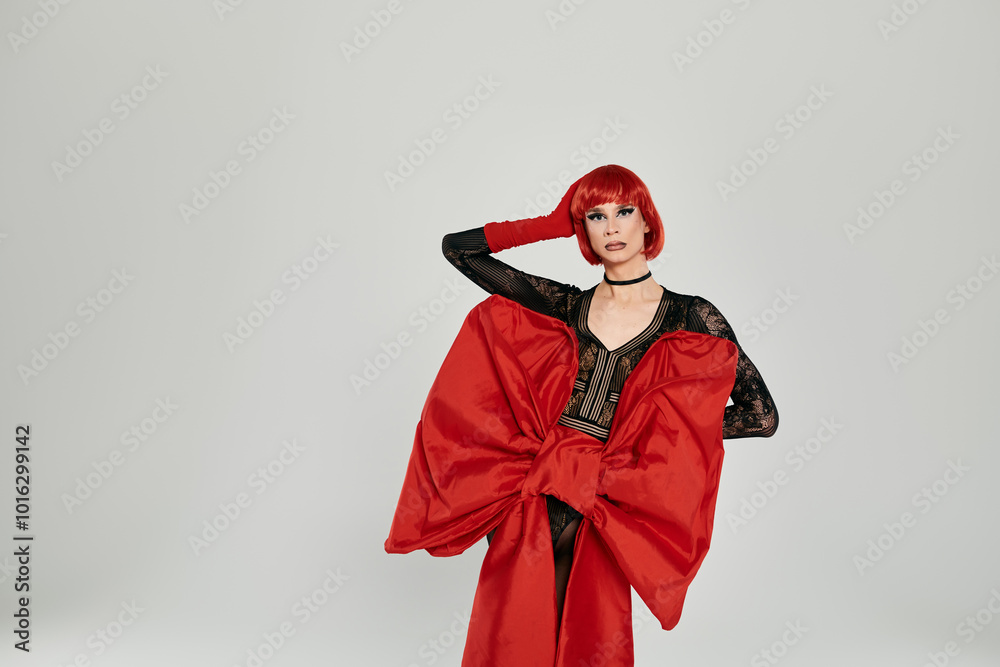 A striking drag queen showcases a dramatic red look with confidence and flair. A striking drag queen showcases a dramatic red look with confidence and flair.