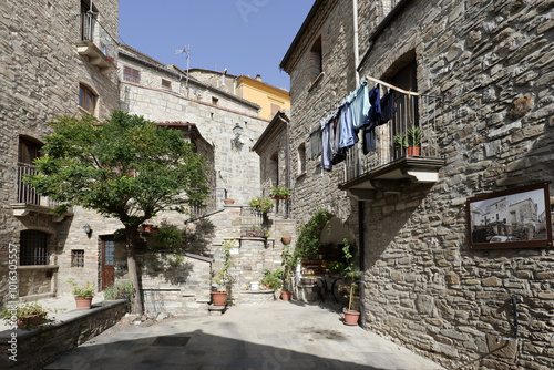 Fototapeta Naklejka Na Ścianę i Meble -  A small street among the old houses of a Guardia Perticara, small town in Basilicata, Italy.