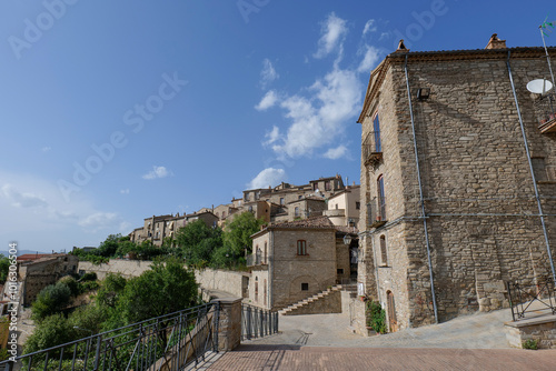 Fototapeta Naklejka Na Ścianę i Meble -  A small street among the old houses of a Guardia Perticara, small town in Basilicata, Italy.