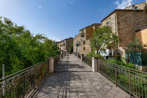 Fototapeta Naklejka Na Ścianę i Meble -  A small street among the old houses of a Guardia Perticara, small town in Basilicata, Italy.