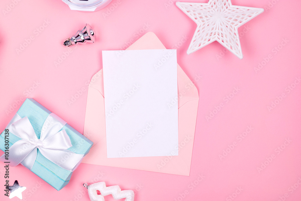 Holidays gift box wrapped in blue paper, balls, glitter on pink background Holidays gift box wrapped in blue paper, balls, glitter on pink background