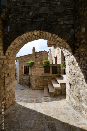 A small street among the old houses of a Guardia Perticara, small town in Basilicata, Italy. photo