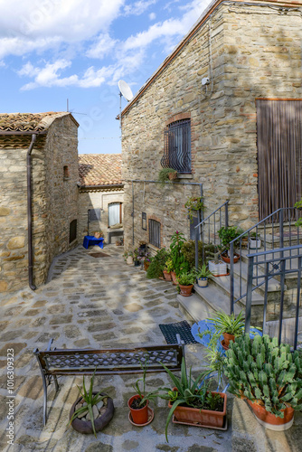 A small street among the old houses of a Guardia Perticara, small town in Basilicata, Italy. photo