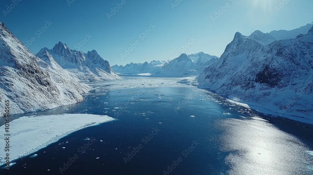 Aerial view of a frozen fjord with snow-capped mountains in the background. Aerial view of a frozen fjord with snow-capped mountains in the background.