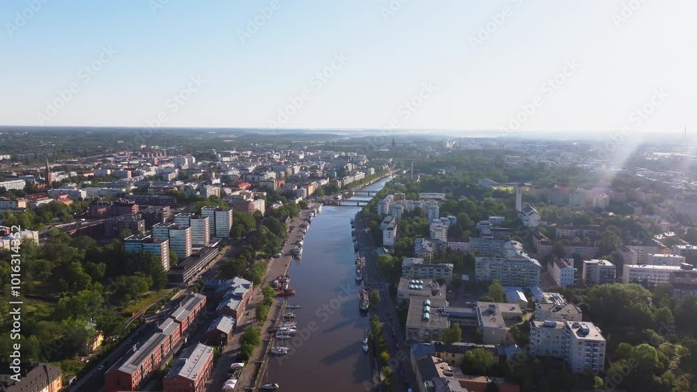 Aerial view of the Aura River flowing through the city center of Turku, Finland. The river is lined with buildings and trees Aerial view of the Aura River flowing through the city center of Turku, Finland. The river is lined with buildings and trees