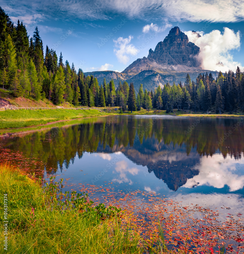 Fototapeta premium Tre Cime di Lavaredo (Drei Zinnen) peak reflected in the calm waters of Antorno lake. Beautiful summer view of Dolomite Alps, Italy, Europe. Travel the world..