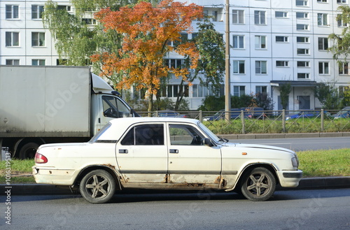 An old white Soviet car is parked on the road, Solidarity Avenue, St. Petersburg, Russia, October 07, 2024 photo