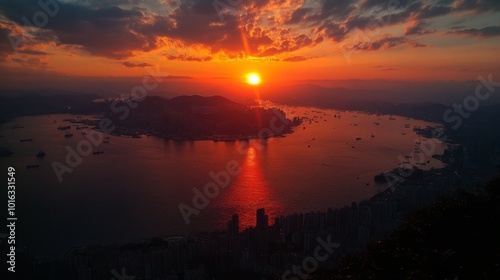 A vibrant sunset over a city skyline with a large body of water in the foreground.