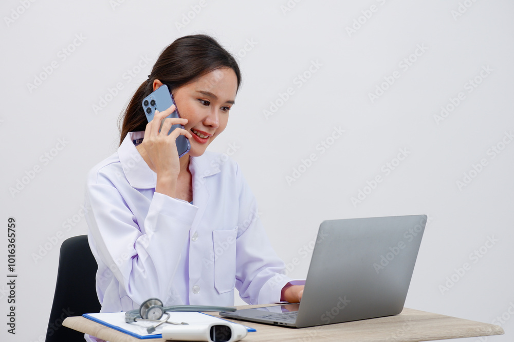 Smiling female doctor using smartphone in medical work. Smiling female doctor using smartphone in medical work.