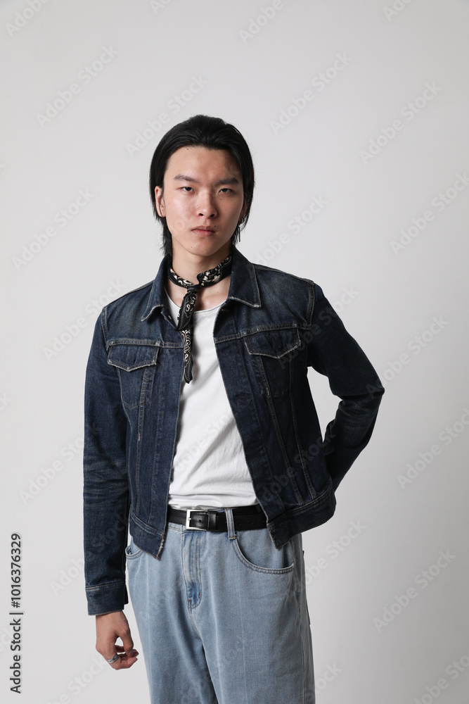 Asian man wearing denim jacket posing indoor over white background. Mock-up. Asian man wearing denim jacket posing indoor over white background. Mock-up.