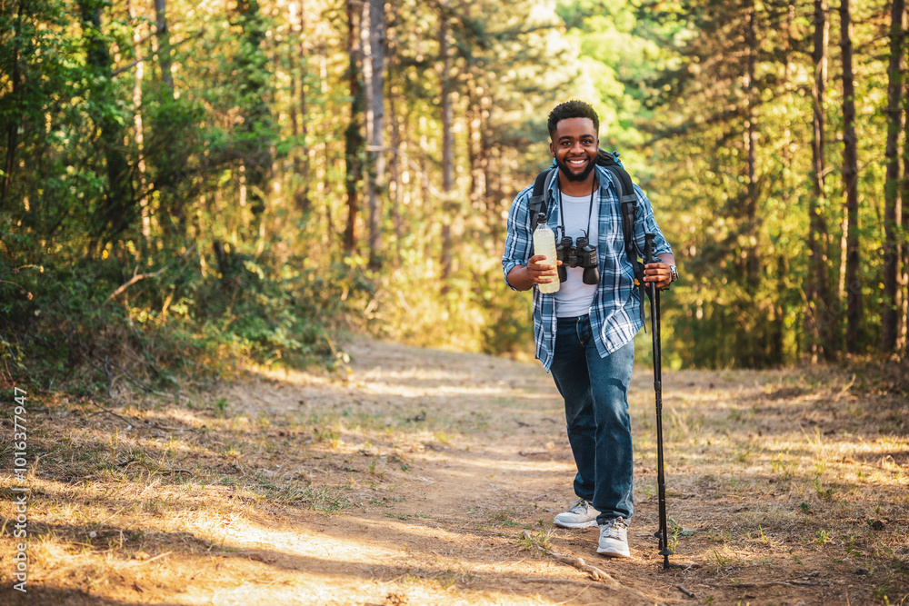 Young man enjoys hiking and drinking energy drink. Young man enjoys hiking and drinking energy drink.