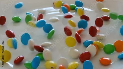 Falling colorful chocolate candies on a white background