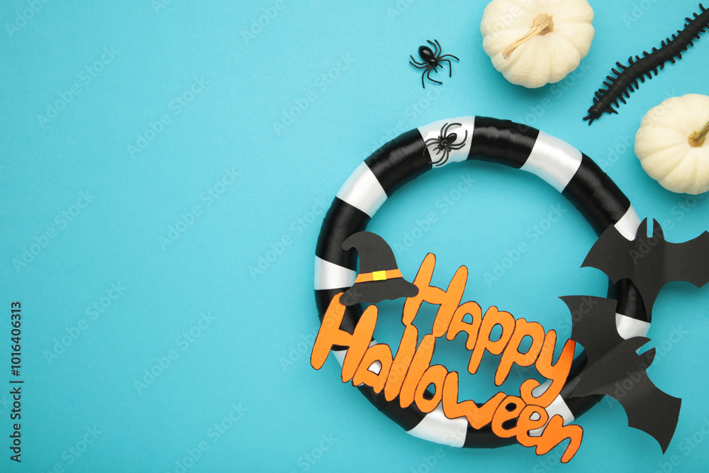 Halloween wreath with mini pumpkins on blue background. Thanksgiving decor. Top view Halloween wreath with mini pumpkins on blue background. Thanksgiving decor. Top view