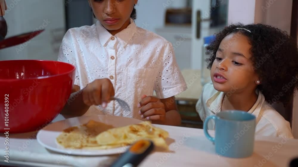 African American funny daughter girl taste eat pancakes while multiethnic family cooking pancakes dinner breakfast at cosy kitchen at home. Multiracial family tradition weekend leisure African American funny daughter girl taste eat pancakes while multiethnic family cooking pancakes dinner breakfast at cosy kitchen at home. Multiracial family tradition weekend leisure