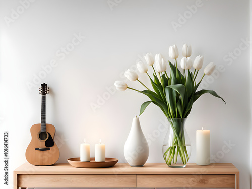 Scandinavian Minimalist home interior details - bouquet of white tulip flowers in vase, candles, Buddha statuette on wooden cabinet. Green house plants and acoustic guitar near white wall with shadow