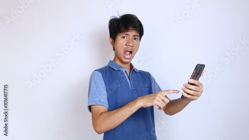 Asian young man surprised and strange gesture holding smartphone