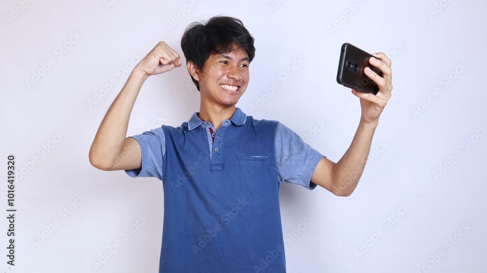 happy asian youth playing games on smartphone happy asian youth playing games on smartphone