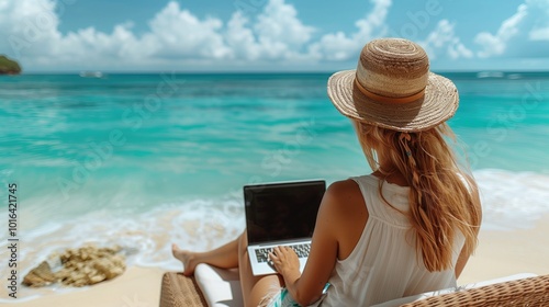 Fototapeta Naklejka Na Ścianę i Meble -  a woman lying on a sunbed at the beach in bali. he is programming on a laptop