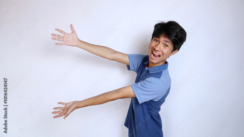 excited and happy asian young man gestures pointing to the side excited and happy asian young man gestures pointing to the side