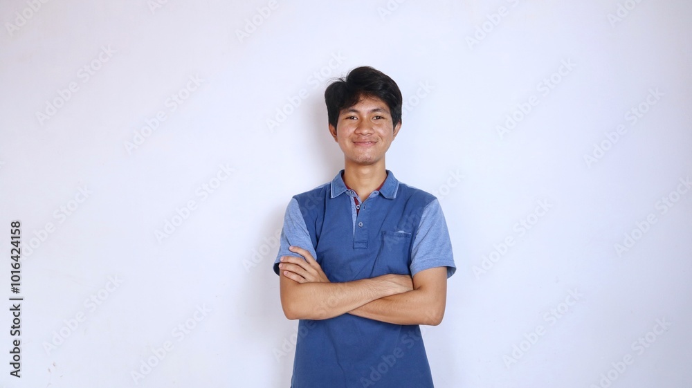 handsome asian young man smiling crossing his arms handsome asian young man smiling crossing his arms