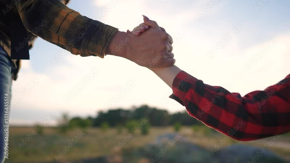 Group tourists helps lend a helping hand. Teamwork business travel concept. The man extends his hand and girl helps her climb rocks. Group tourists help lifestyle each other suive on their journey.