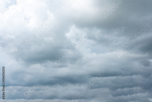 Fluffy white clouds drift across a clear blue sky, creating a beautiful and peaceful cloudscape