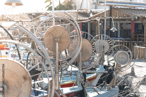 Fishing boats with empty reels docked at pier on sunny day. Ayia Napa, Cyprus photo