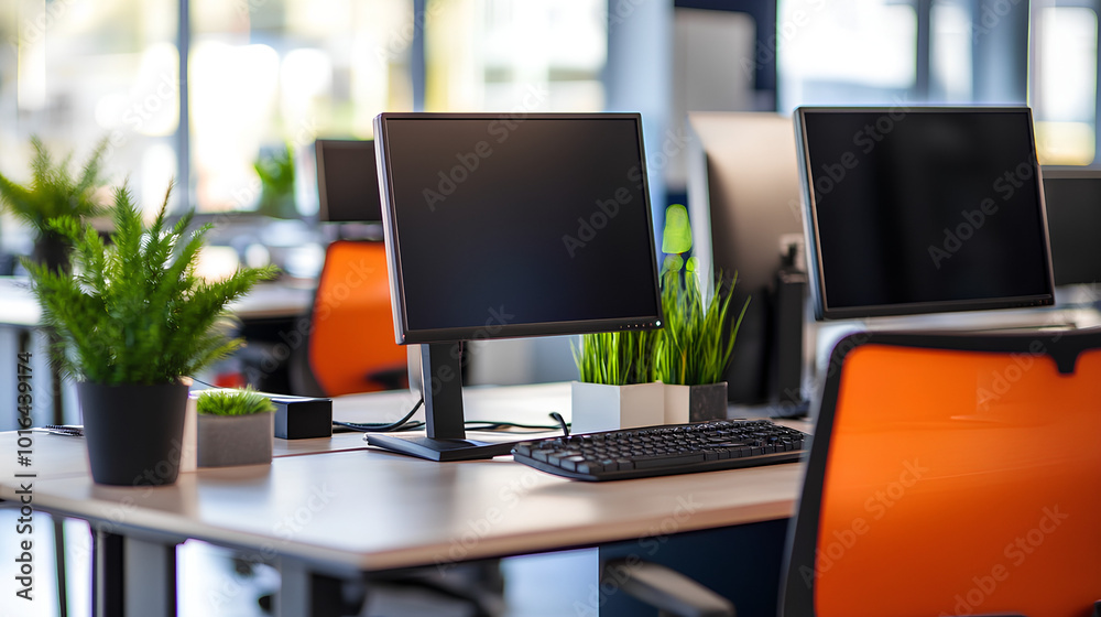 A modern office workspace with a computer monitor, keyboard, and plants on a clean desk.