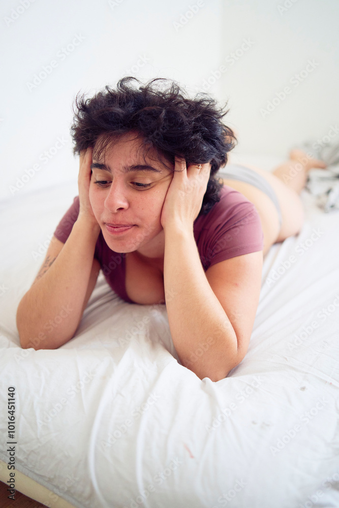 tired young plus size woman in home clothes on bed in student dormitory tired young plus size woman in home clothes on bed in student dormitory