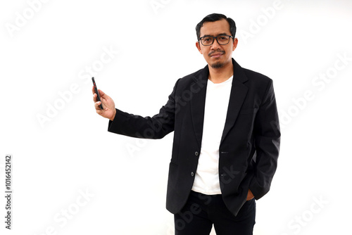 Smiling Asian man in semi formal suit using mobile phone. Isolated on white background photo