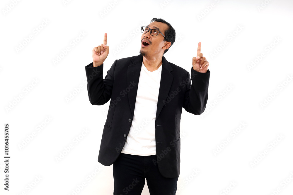 Asian businessman pointing fingers and looking upward, isolated on white background Asian businessman pointing fingers and looking upward, isolated on white background