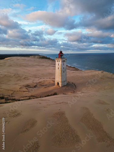 Rubjerg knude lighthouse on the west coast of denmark during a beautiful sunset sunrise golden hour photo