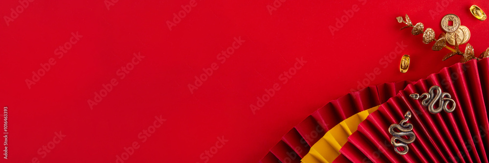 Fototapeta premium Chinese asia New Year golden red background. New zodiac year Snake 2025 greeting card. Red flat lay background with holiday fans, wishes envelopes, snake statue in traditional chinese style