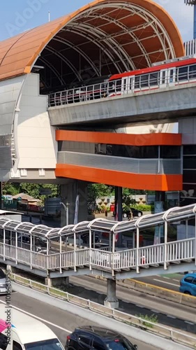 Jakarta, Indonesia on April 8 2024. The atmosphere in the Cawang Ciliwung area, where the KAI Ciliwung LRT station and the Transjakarta bus stop are next to each other and are connected by a pedestria photo