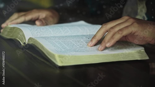 asian woman reading the Christian bible book on wooden table vintage room	
