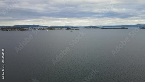 Aerial Drone Shot of a Ferry Cruising Through the Ocean Under Overcast Skies in Stavanger, Norway photo