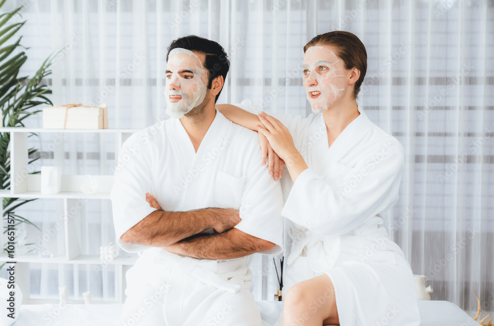 Fototapeta premium Serene modern daylight ambiance of spa salon, couple customer indulges in rejuvenating with facial skincare mask. Facial skin treatment and beauty cosmetology procedure for face. Quiescent