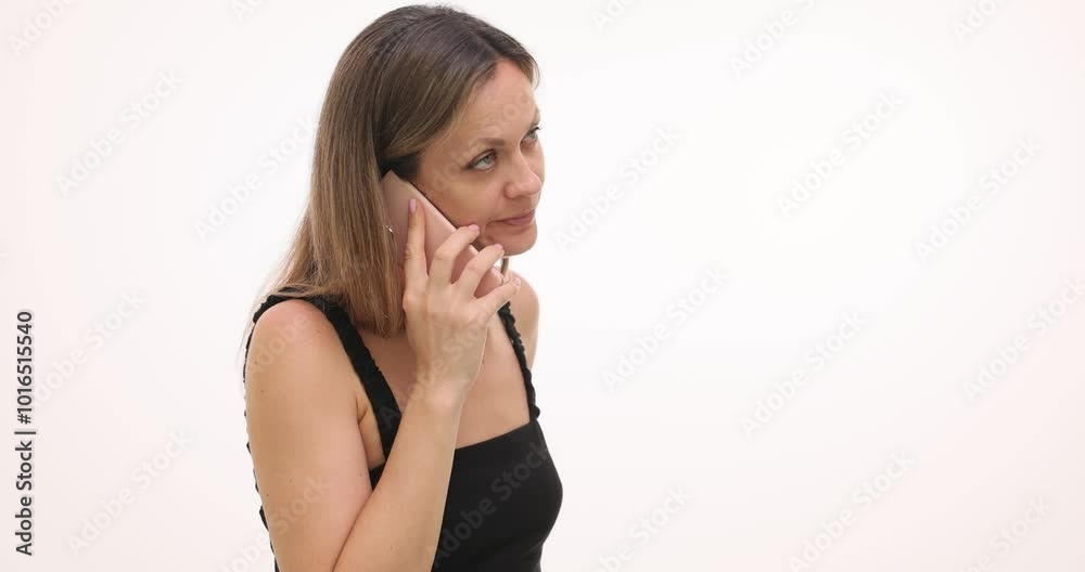 Irritated woman tries to get through to acquaintance on white background. Annoyed blonde in tank top dials phone number repeatedly slow motion Irritated woman tries to get through to acquaintance on white background. Annoyed blonde in tank top dials phone number repeatedly slow motion