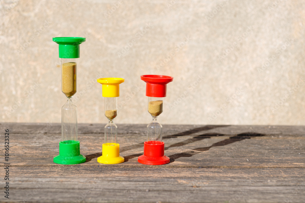 Hourglasses on rustic wooden table Hourglasses on rustic wooden table