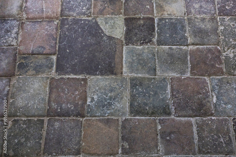 Closeup of a brick floor displaying a checkered pattern
