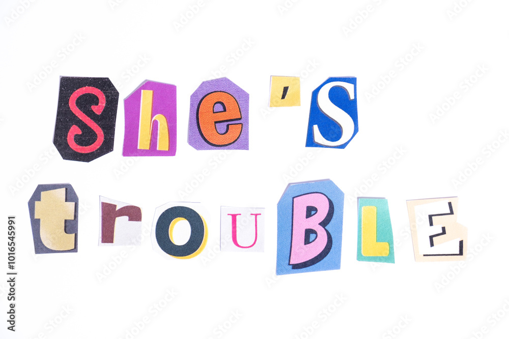 Phrase She's Trouble spelled in cut out newspaper style typography isolated on white background. Phrase She's Trouble spelled in cut out newspaper style typography isolated on white background.