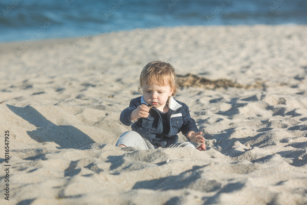 Little baby boy playing on ocean beach. Toddler kid during family sea vacation. Summer water fun. Little baby boy playing on ocean beach. Toddler kid during family sea vacation. Summer water fun.