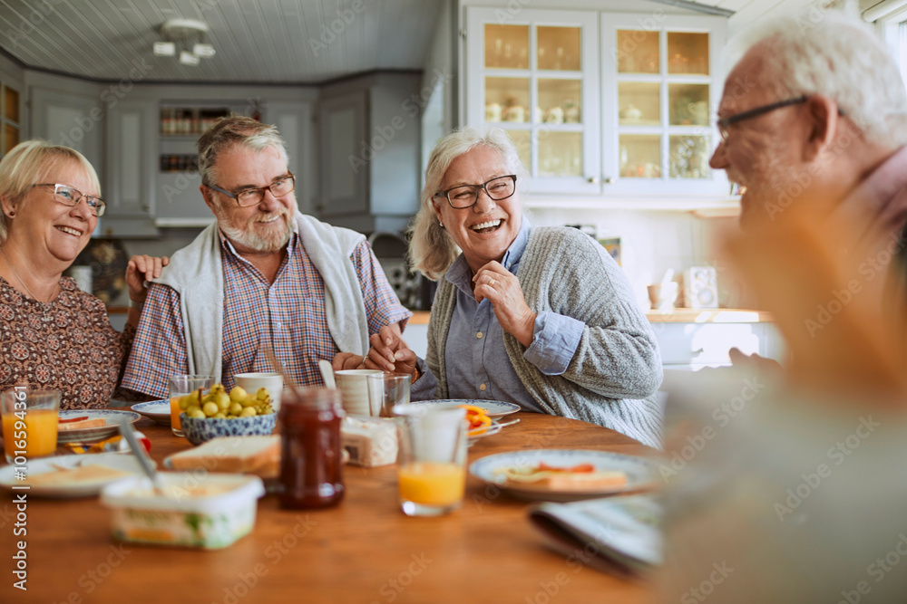 Seniors enjoying breakfast together in cozy kitchen Seniors enjoying breakfast together in cozy kitchen