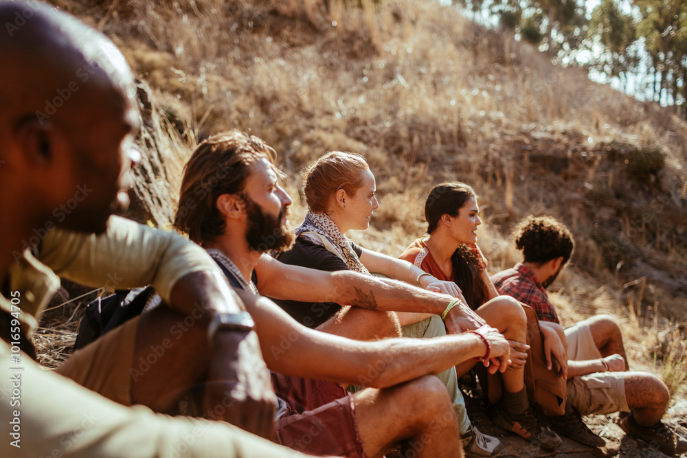 Group of hikers resting on a trail in the mountains Group of hikers resting on a trail in the mountains
