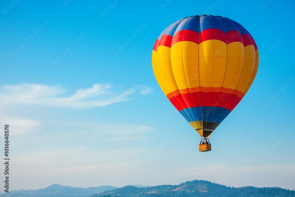 A vibrant hot air balloon soars majestically over Grants Pass, Oregon, on a beautiful summer morning, showcasing the lush landscape of rolling hills under clear blue skies. A vibrant hot air balloon soars majestically over Grants Pass, Oregon, on a beautiful summer morning, showcasing the lush landscape of rolling hills under clear blue skies.