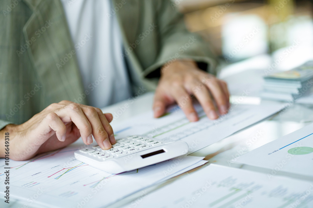 Business analyst calculating turnover figures in office Business analyst calculating turnover figures in office