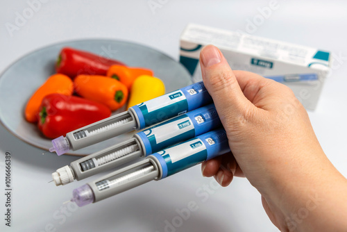 Hands holding Ozempic Insulin injection pen for diabetics and weight loss